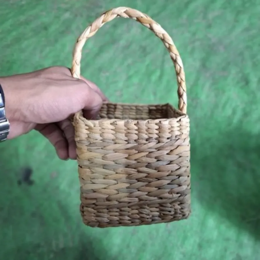 A small woven basket held in a hand